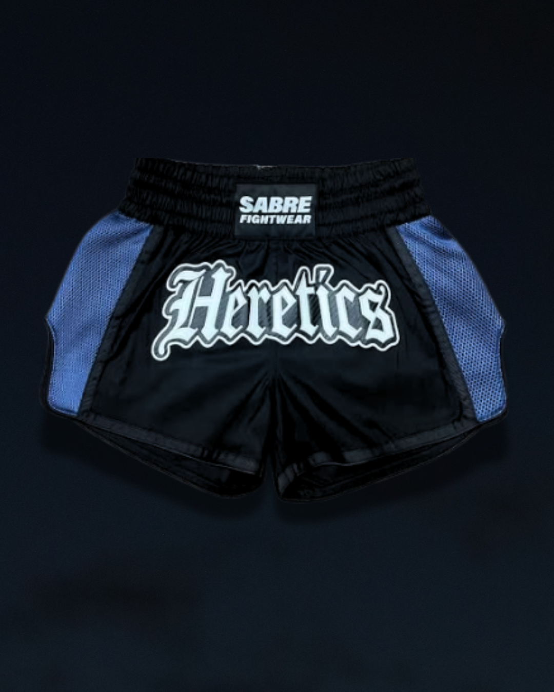 Close-up of the HERETICS design on the limited-edition Sabre Fightwear x Her Fight Network Muay Thai shorts.