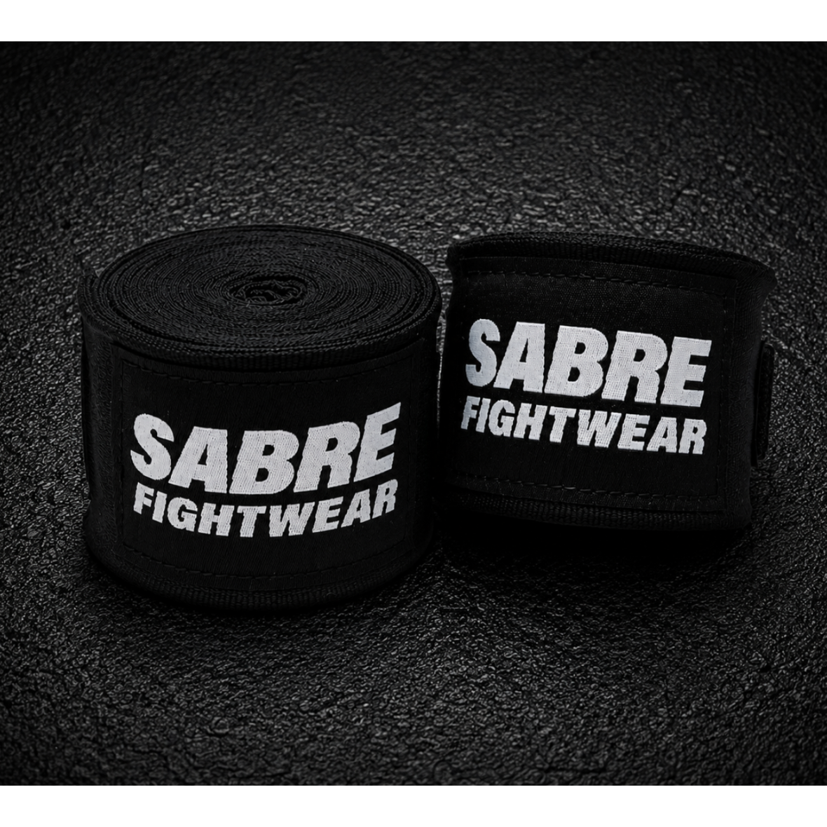 Black boxing hand wraps on a dark textured background